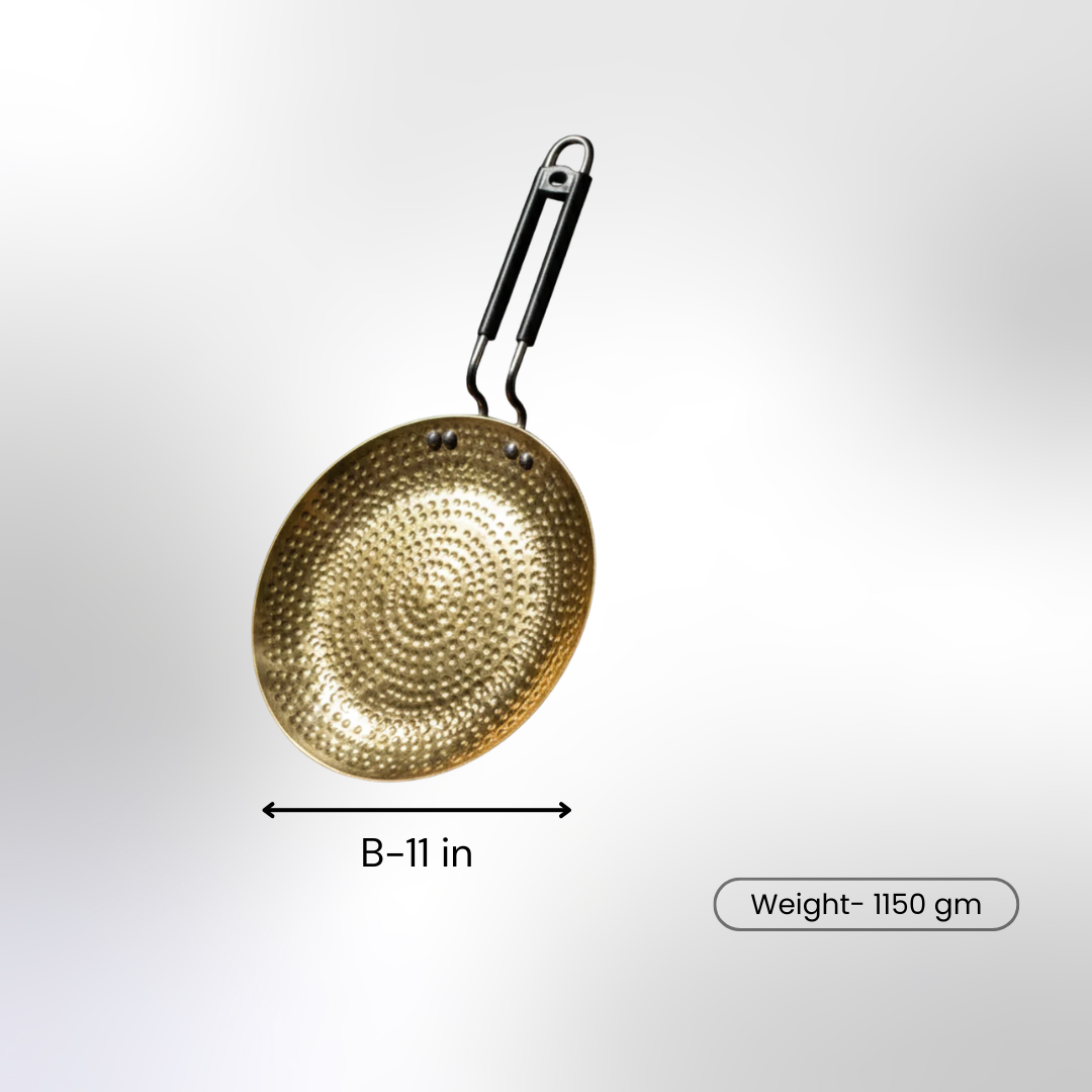 A hammered brass tawa with a black handle shown on a white background, labeled with an 11-inch diameter and 1150 gm weight.